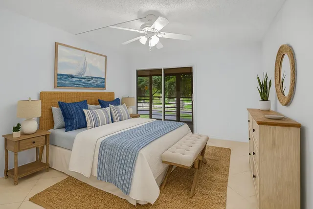 a bedroom with a bed a dresser and a window