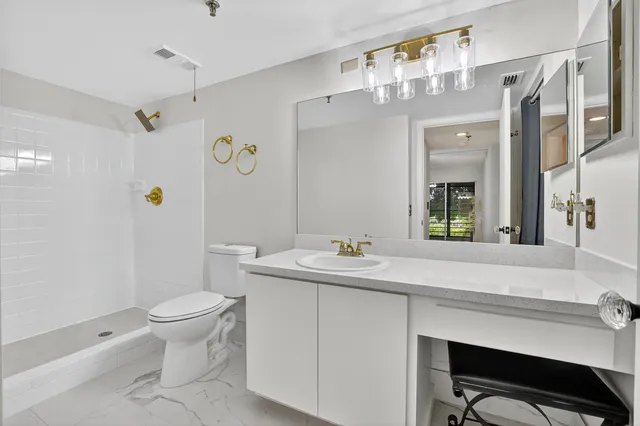 a bathroom with a sink a toilet and a mirror