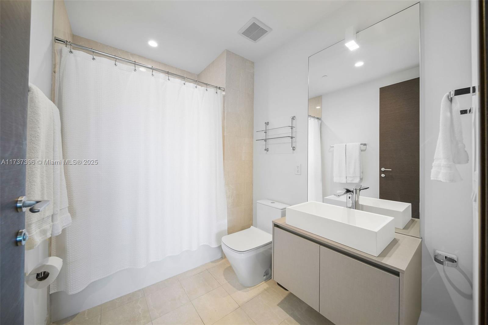 1000 Brickell Plaza, Unit PH5002 Miami, FL 33131 - Photo 37 of 68 a bathroom with a double vanity sink mirror and toilet