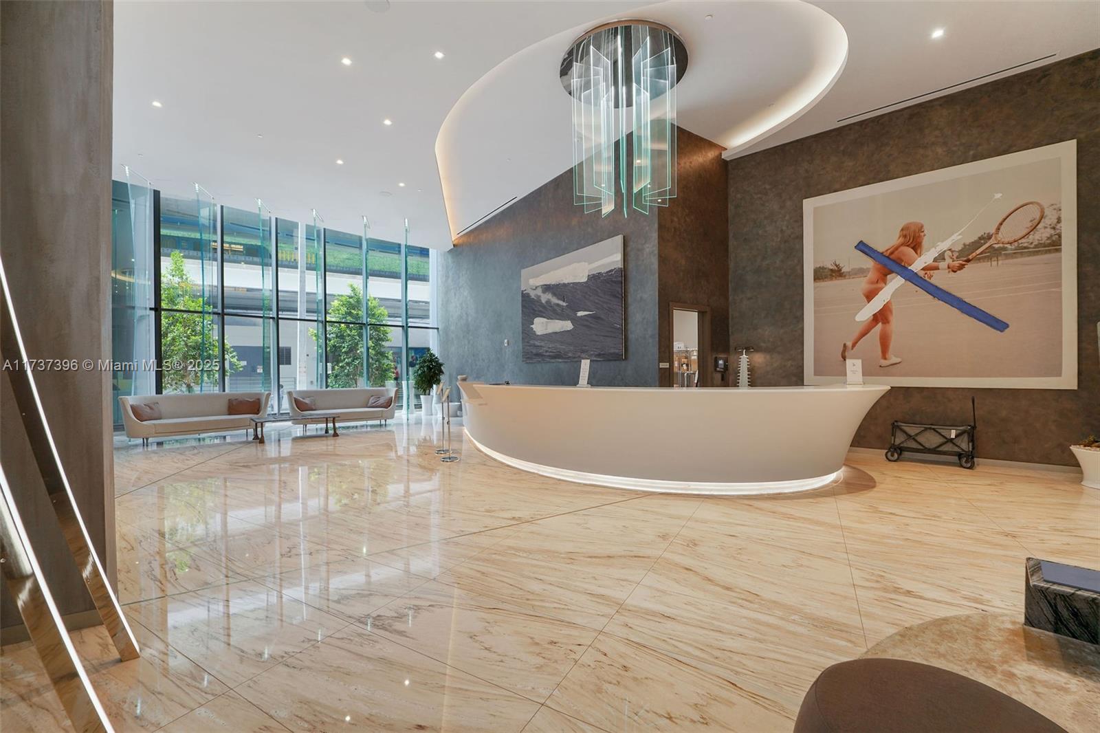 1000 Brickell Plaza, Unit PH5002 Miami, FL 33131 - Photo 44 of 68 a view of a livingroom with a dinning area hardwood floor and a ceiling fan