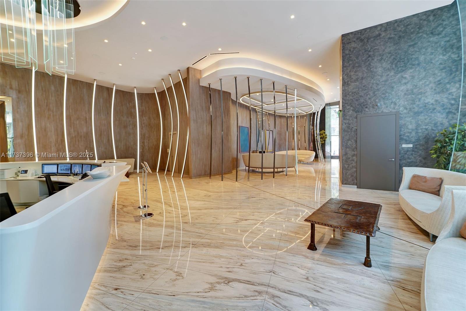 1000 Brickell Plaza, Unit PH5002 Miami, FL 33131 - Photo 45 of 68 a living room with couches a dining table with wooden floor and potted plants