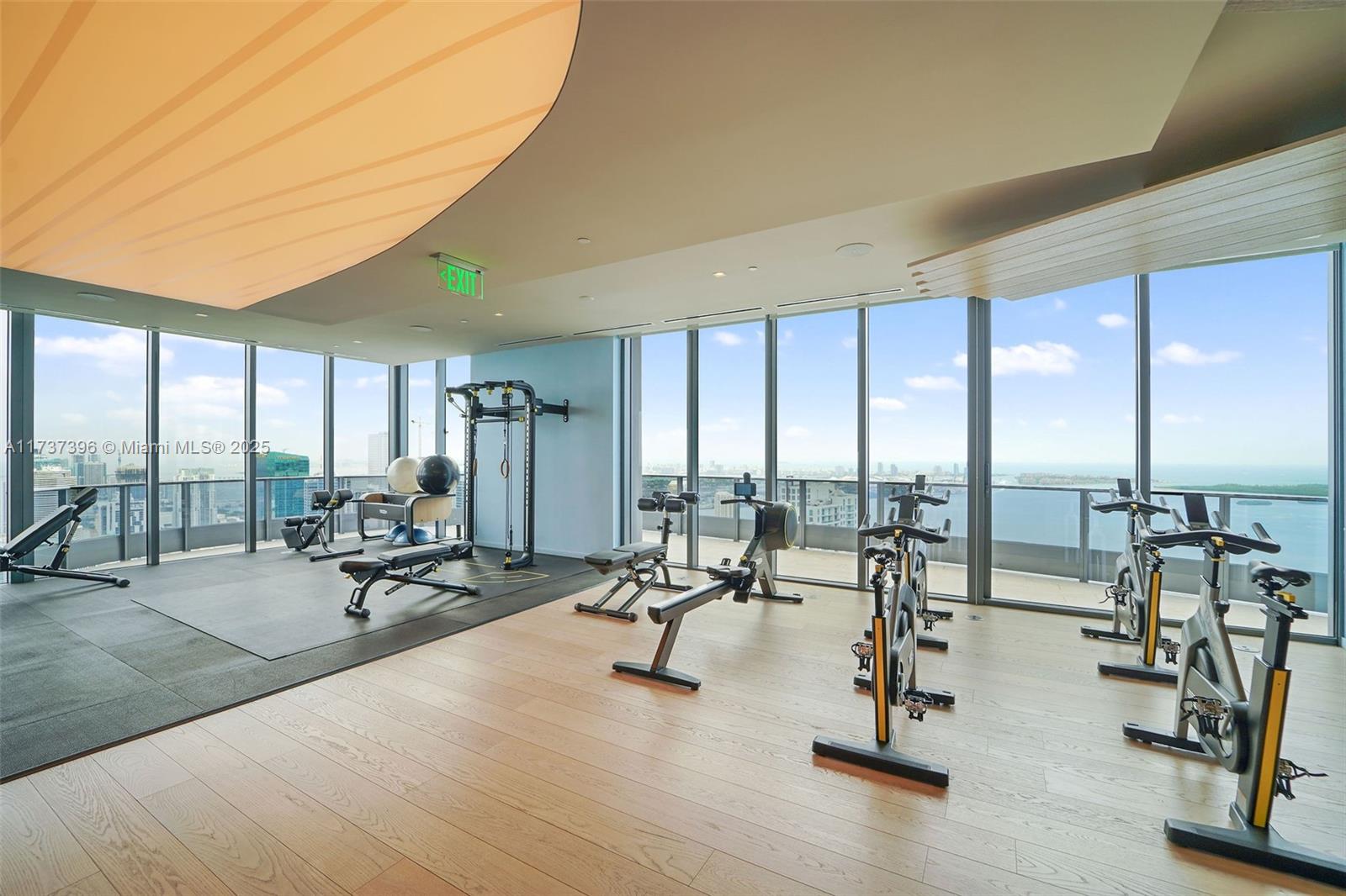 1000 Brickell Plaza, Unit PH5002 Miami, FL 33131 - Photo 65 of 68 a view of a room with gym equipment and floor to ceiling window