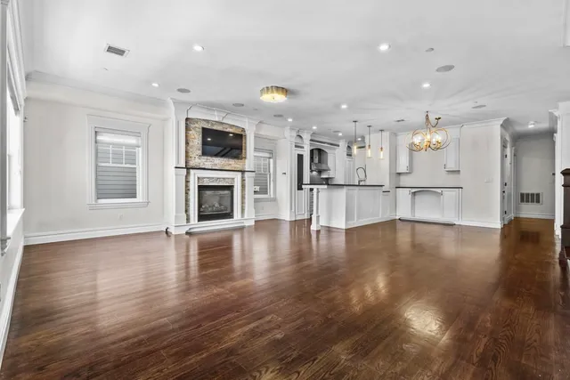 a view of a kitchen with a flat screen tv and wooden floor