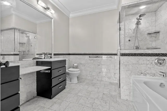 a bathroom with a bathtub sink mirror and toilet