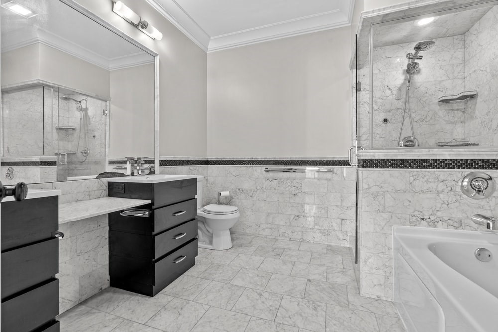 161 Tudor Street, Unit 4 Boston, MA 02127 - Photo 15 of 34 a bathroom with a bathtub sink mirror and toilet