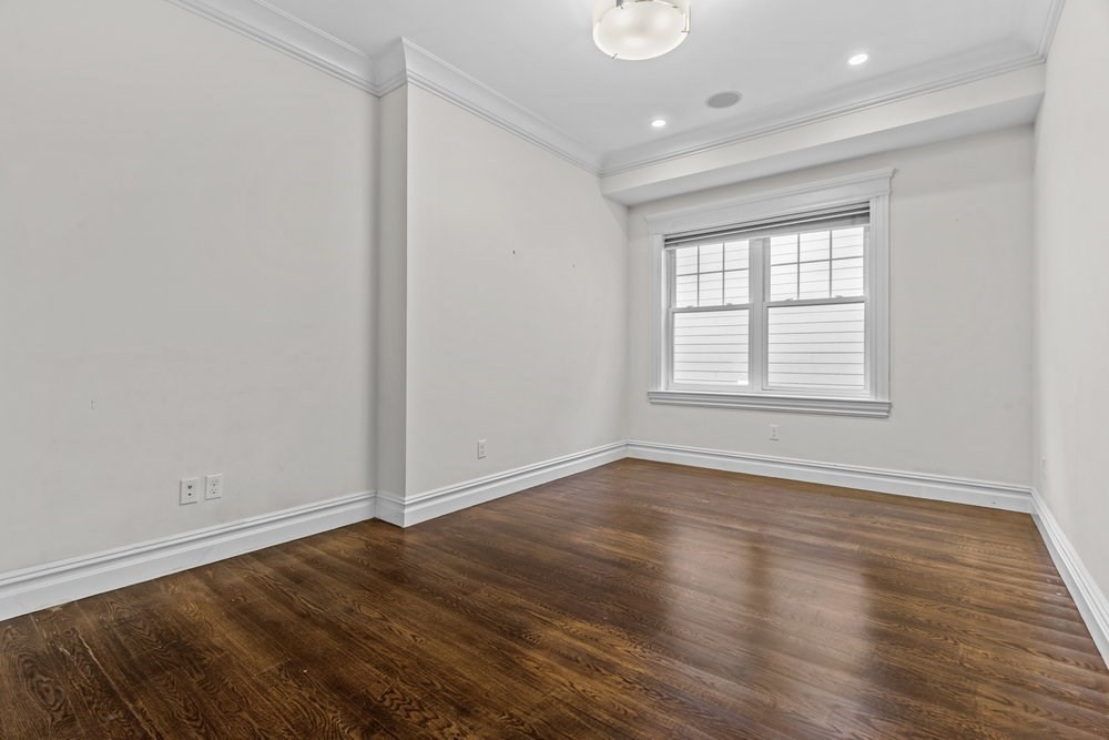 161 Tudor Street, Unit 4 Boston, MA 02127 - Photo 18 of 34 wooden floor in an empty room with a window