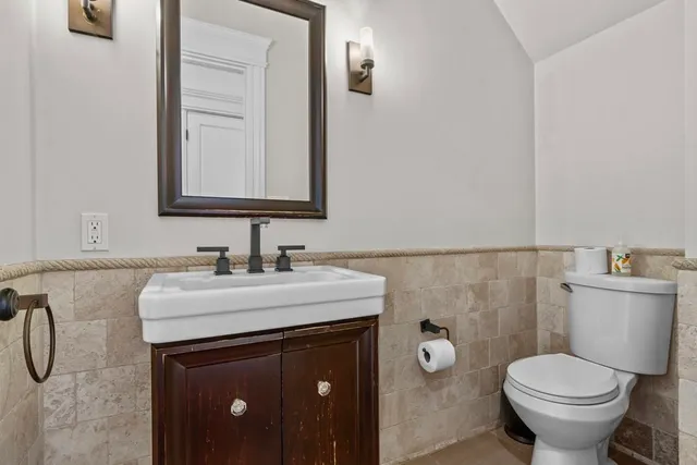a bathroom with a sink vanity and toilet