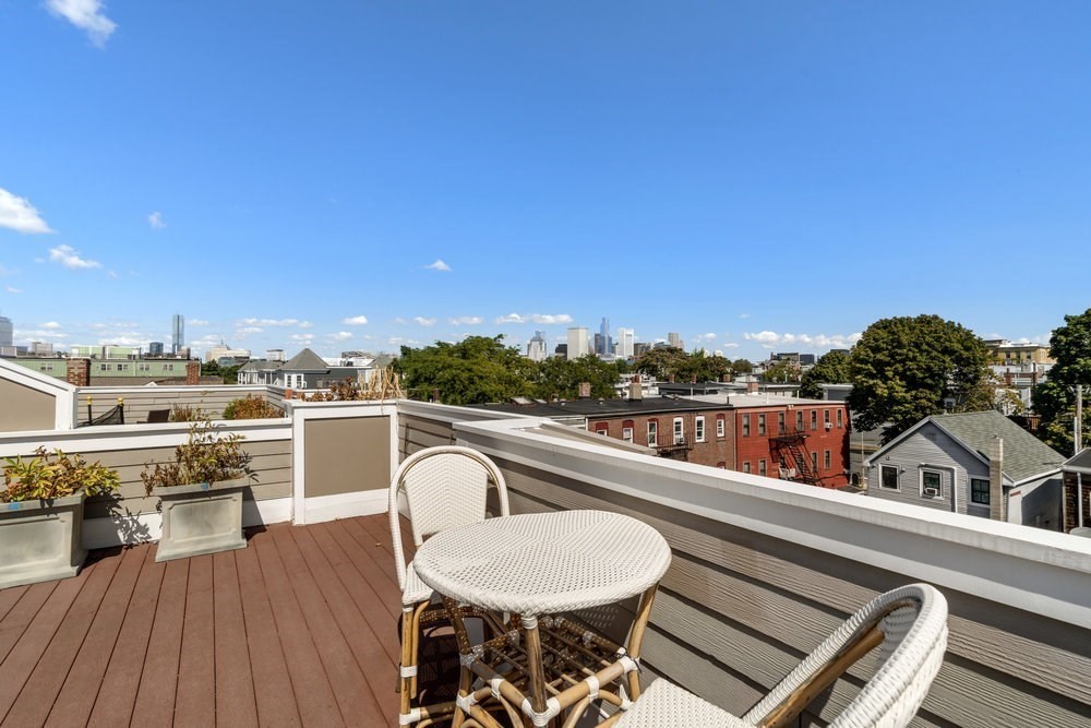 161 Tudor Street, Unit 4 Boston, MA 02127 - Photo 27 of 34 a view of a balcony with furniture and wooden floor