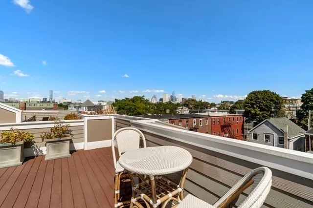 a view of a balcony with furniture and wooden floor