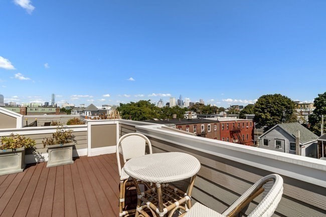 161 Tudor Street, Unit 4 Boston, MA 02127 - Photo 28 of 34 a view of a balcony with furniture and wooden floor