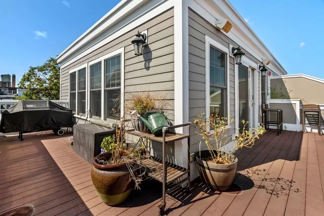 a view of a house with patio filled with furniture