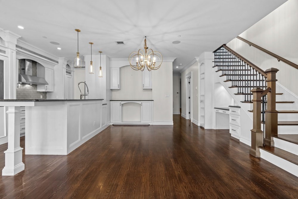 161 Tudor Street, Unit 4 Boston, MA 02127 - Photo 9 of 34 a view of a kitchen with wooden floor and electronic appliances