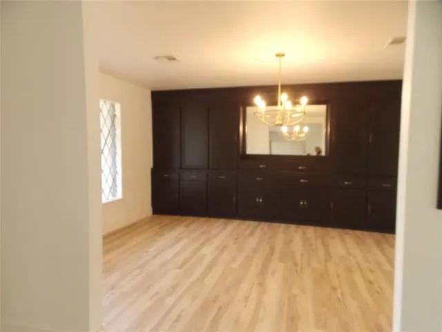 a bathroom with a window and chandelier