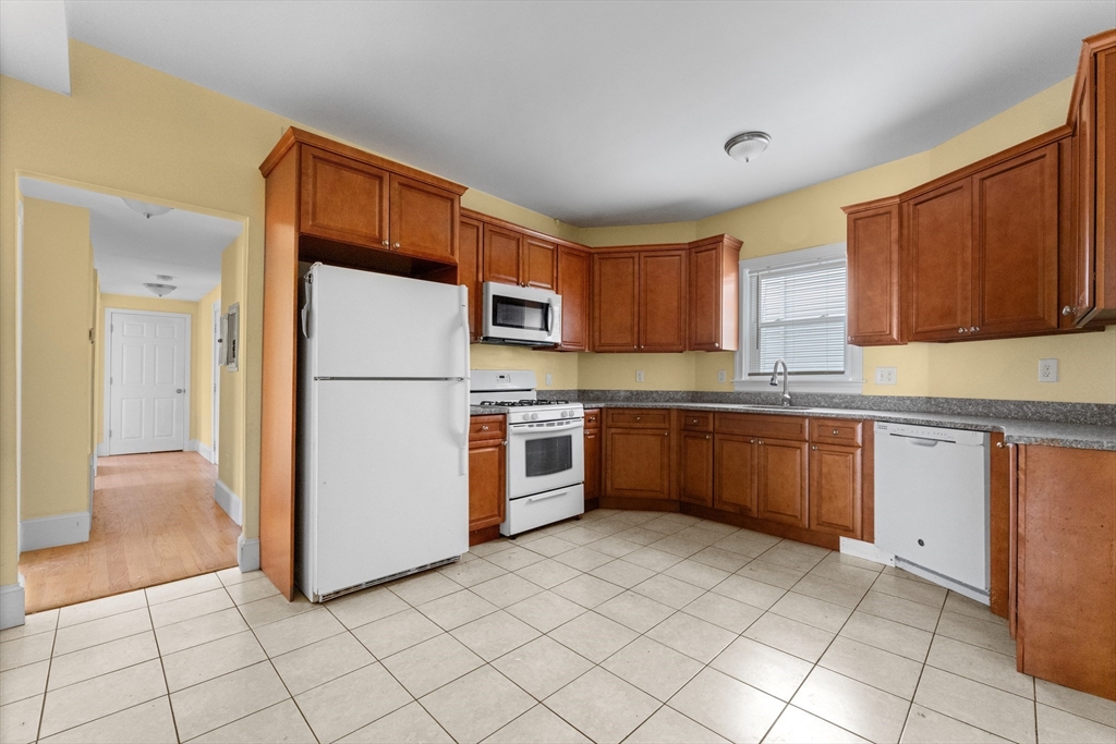 a kitchen with stainless steel appliances granite countertop a refrigerator sink and cabinets
