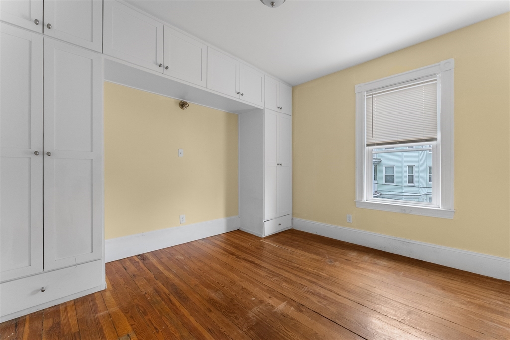 571 Washington Street, Unit 2 Boston, MA 02135 - Photo 6 of 13 a view of empty room with wooden floor