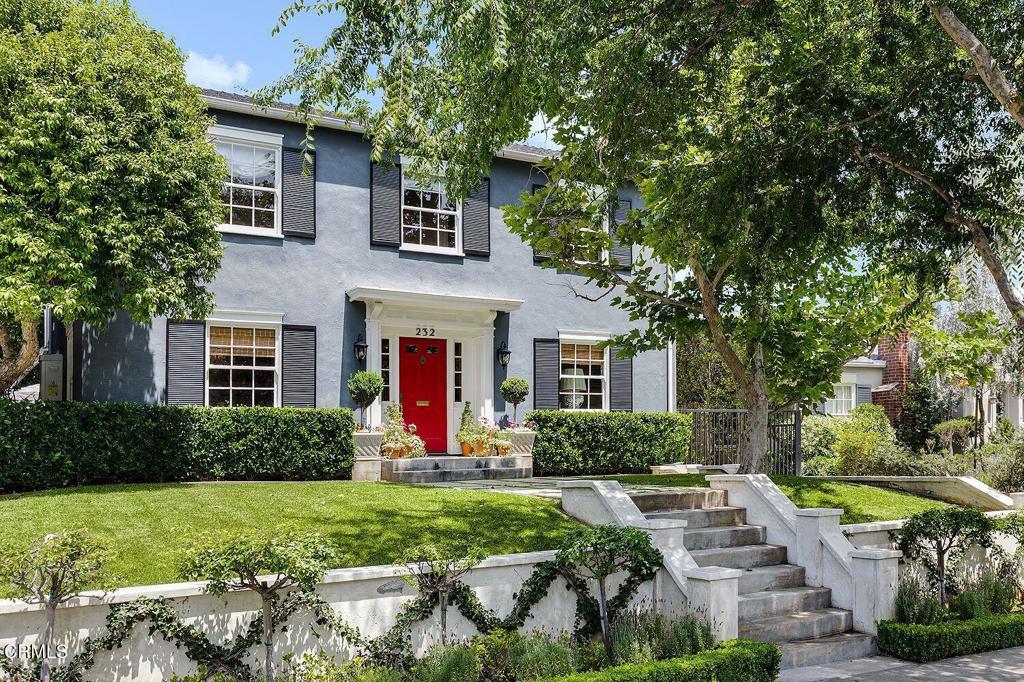 a front view of house with yard and green space