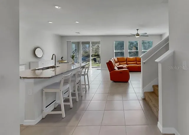 a kitchen with stainless steel appliances granite countertop a sink and a refrigerator