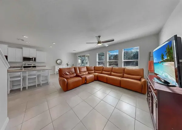 a living room with furniture and a chandelier