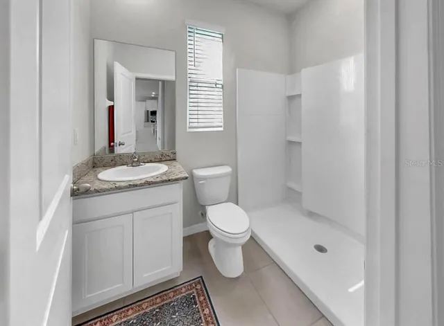 a bathroom with a glass shower door