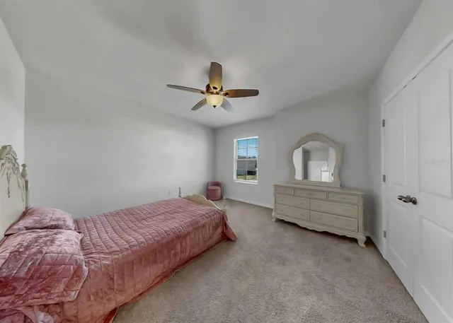 an aerial view of a house with a yard and lake