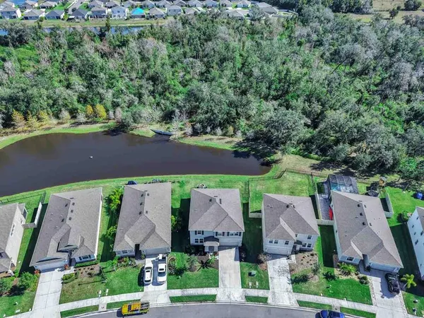 a view of a lake with houses in the back