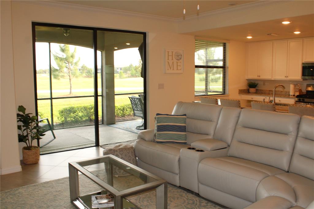18017 Gawthrop Drive, Unit 104 Bradenton, FL 34211 - Photo 11 of 54 a living room with furniture and a large window