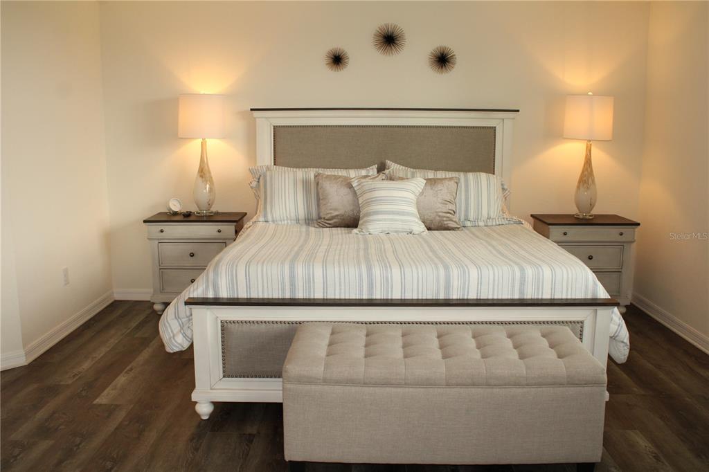 18017 Gawthrop Drive, Unit 104 Bradenton, FL 34211 - Photo 13 of 54 a bedroom with a bed and wooden floor