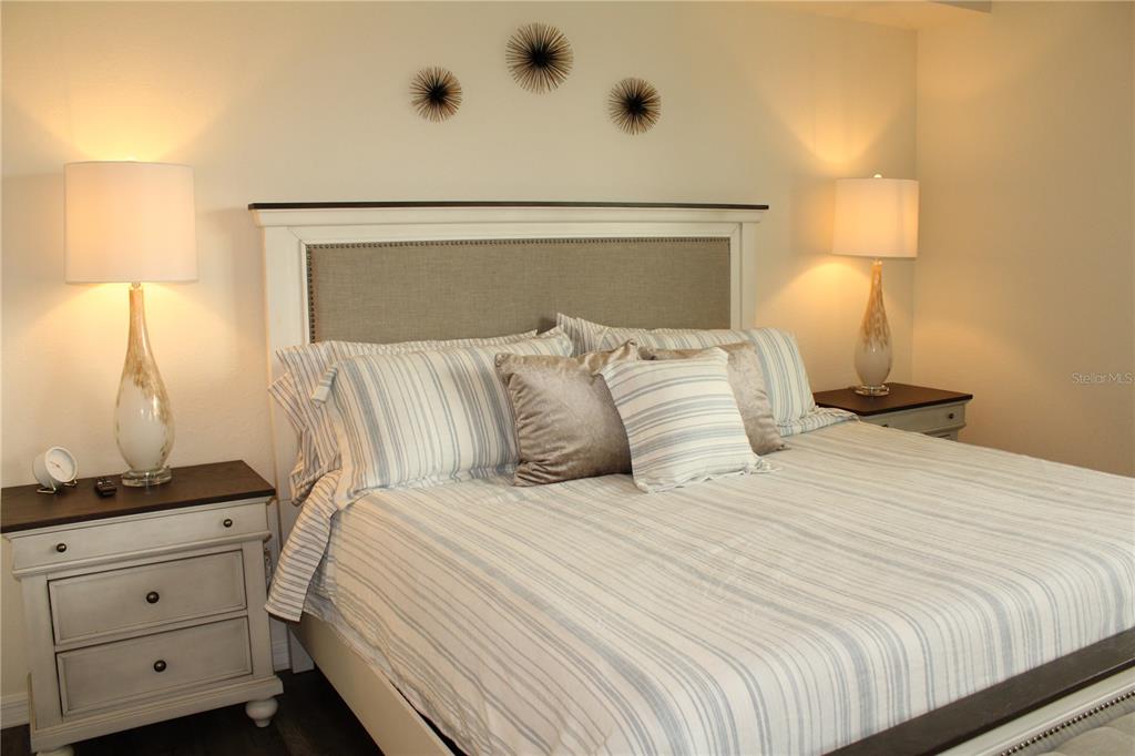 18017 Gawthrop Drive, Unit 104 Bradenton, FL 34211 - Photo 14 of 54 a bedroom with a bed and a night stand