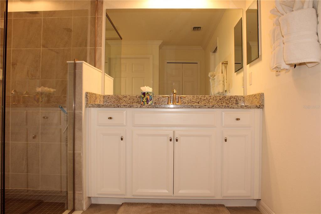 18017 Gawthrop Drive, Unit 104 Bradenton, FL 34211 - Photo 18 of 54 a bathroom with a granite countertop sink and a mirror