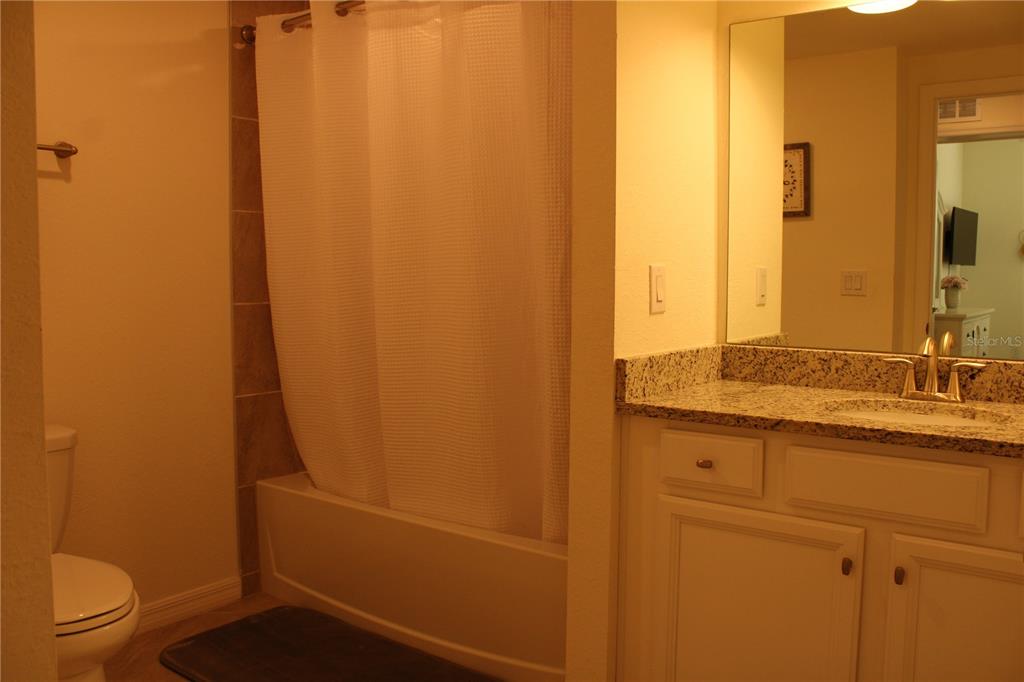 18017 Gawthrop Drive, Unit 104 Bradenton, FL 34211 - Photo 22 of 54 a bathroom with a granite countertop sink toilet and shower