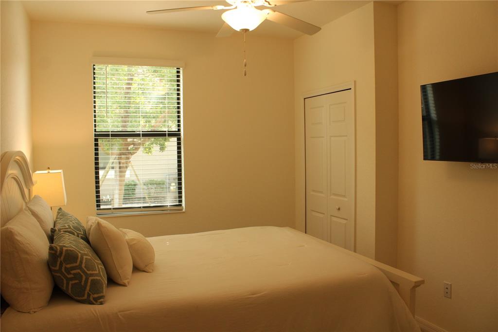 18017 Gawthrop Drive, Unit 104 Bradenton, FL 34211 - Photo 25 of 54 a bedroom with a bed and a chandelier
