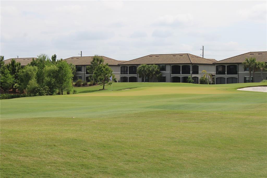 18017 Gawthrop Drive, Unit 104 Bradenton, FL 34211 - Photo 33 of 54 a front view of a house with a yard and potted plants