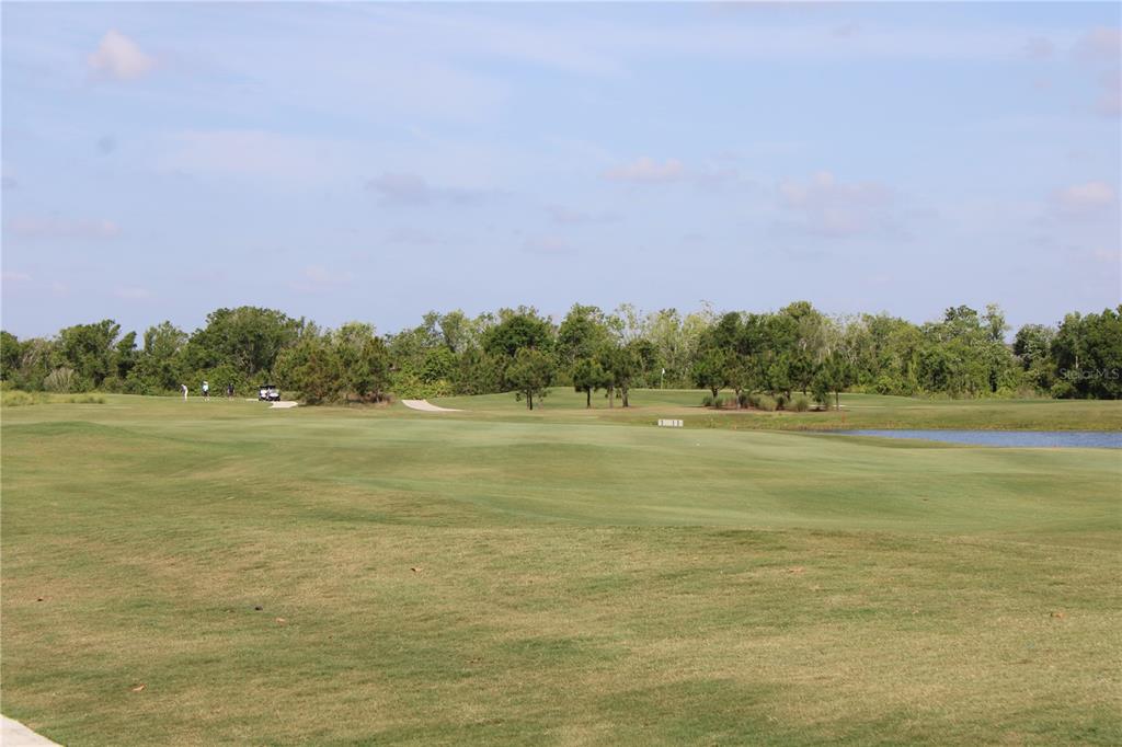 18017 Gawthrop Drive, Unit 104 Bradenton, FL 34211 - Photo 35 of 54 a view of a field with trees in the background