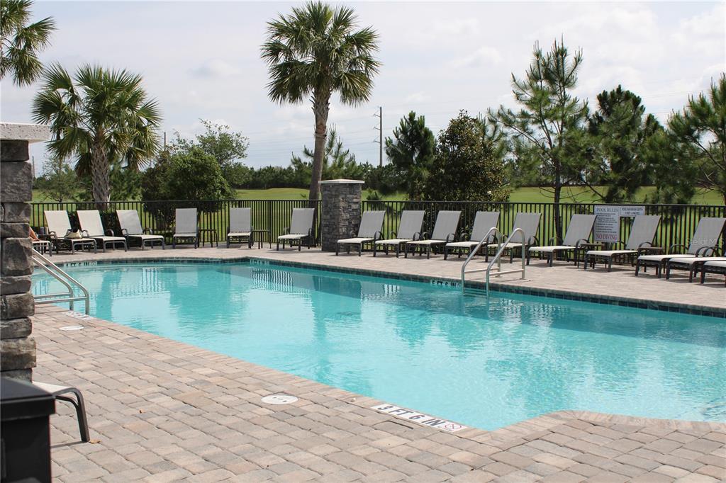 18017 Gawthrop Drive, Unit 104 Bradenton, FL 34211 - Photo 42 of 54 a view of a swimming pool with a table and chairs