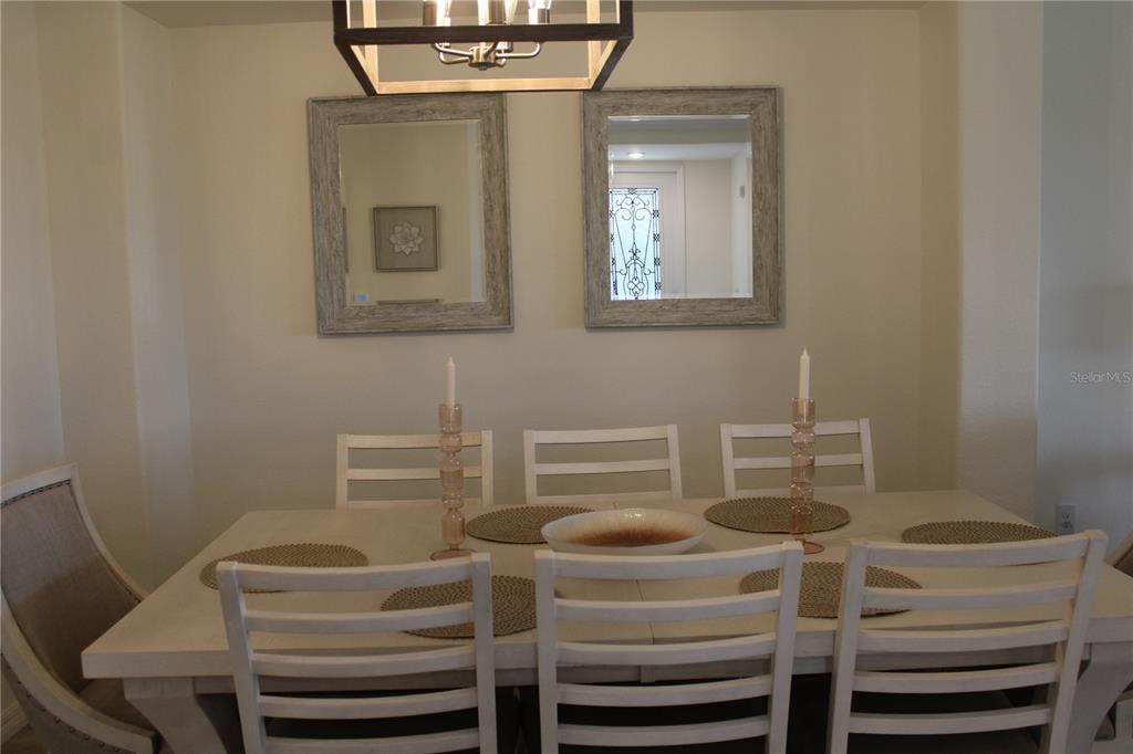 18017 Gawthrop Drive, Unit 104 Bradenton, FL 34211 - Photo 5 of 54 a view of a dining room with furniture and wooden floor