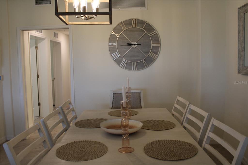 18017 Gawthrop Drive, Unit 104 Bradenton, FL 34211 - Photo 6 of 54 a dining room with a table and chairs