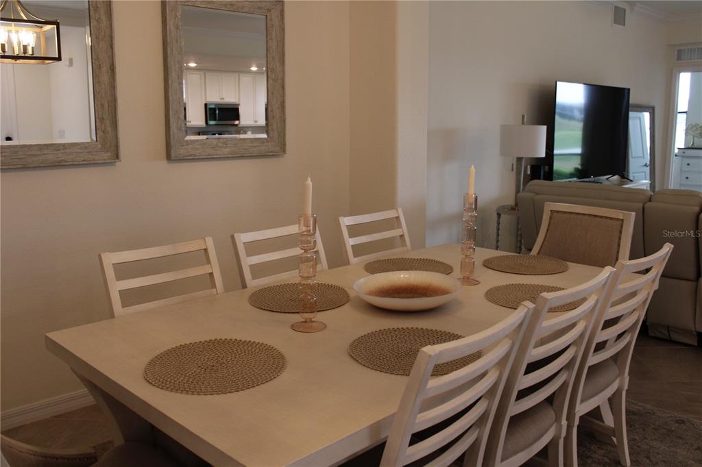 18017 Gawthrop Drive, Unit 104 Bradenton, FL 34211 - Photo 7 of 54 a view of a dining room with furniture and wooden floor
