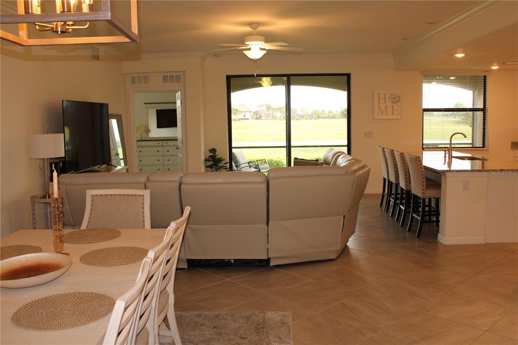 18017 Gawthrop Drive, Unit 104 Bradenton, FL 34211 - Photo 8 of 54 a living room with furniture and a flat screen tv