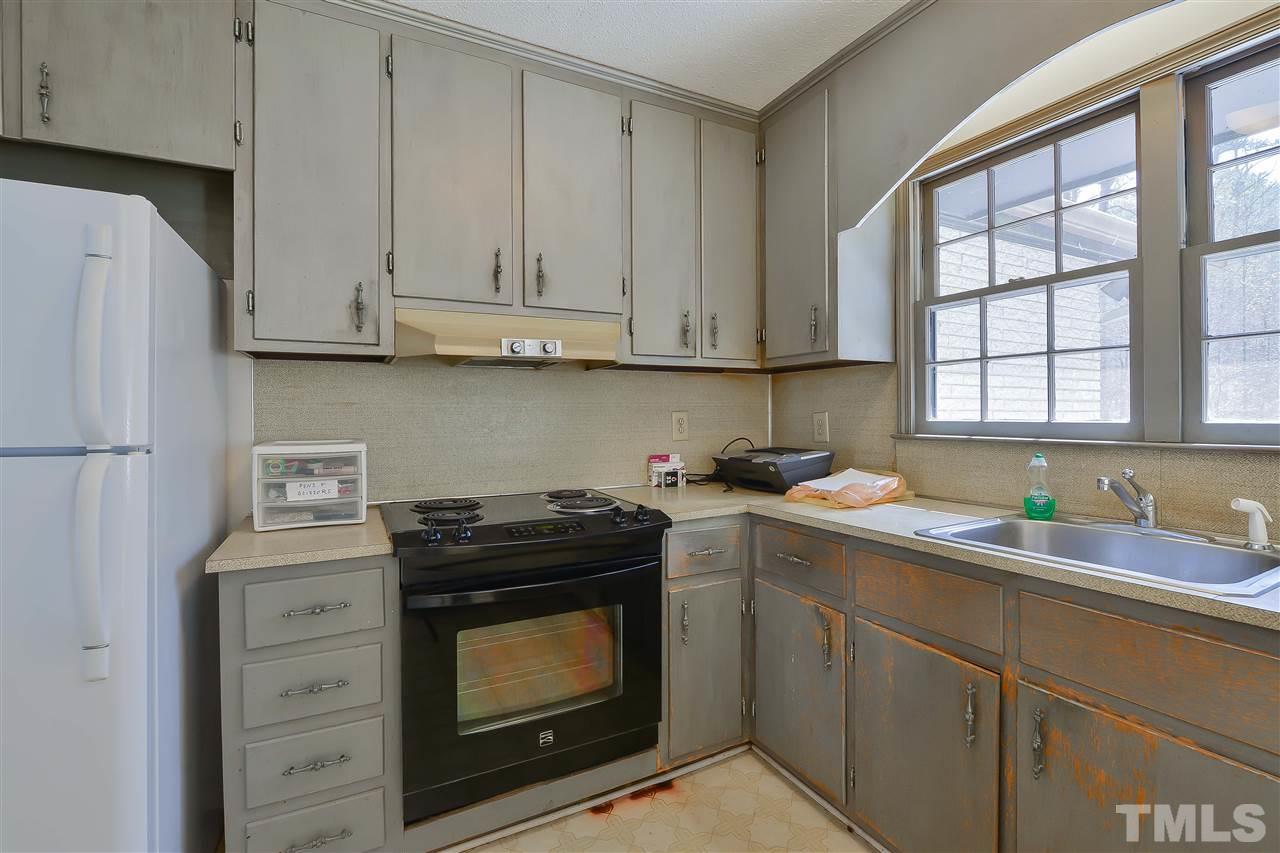 6712 Laurdane Road Raleigh, NC 27613 - Photo 12 of 25 a kitchen with stainless steel appliances granite countertop a sink stove and refrigerator