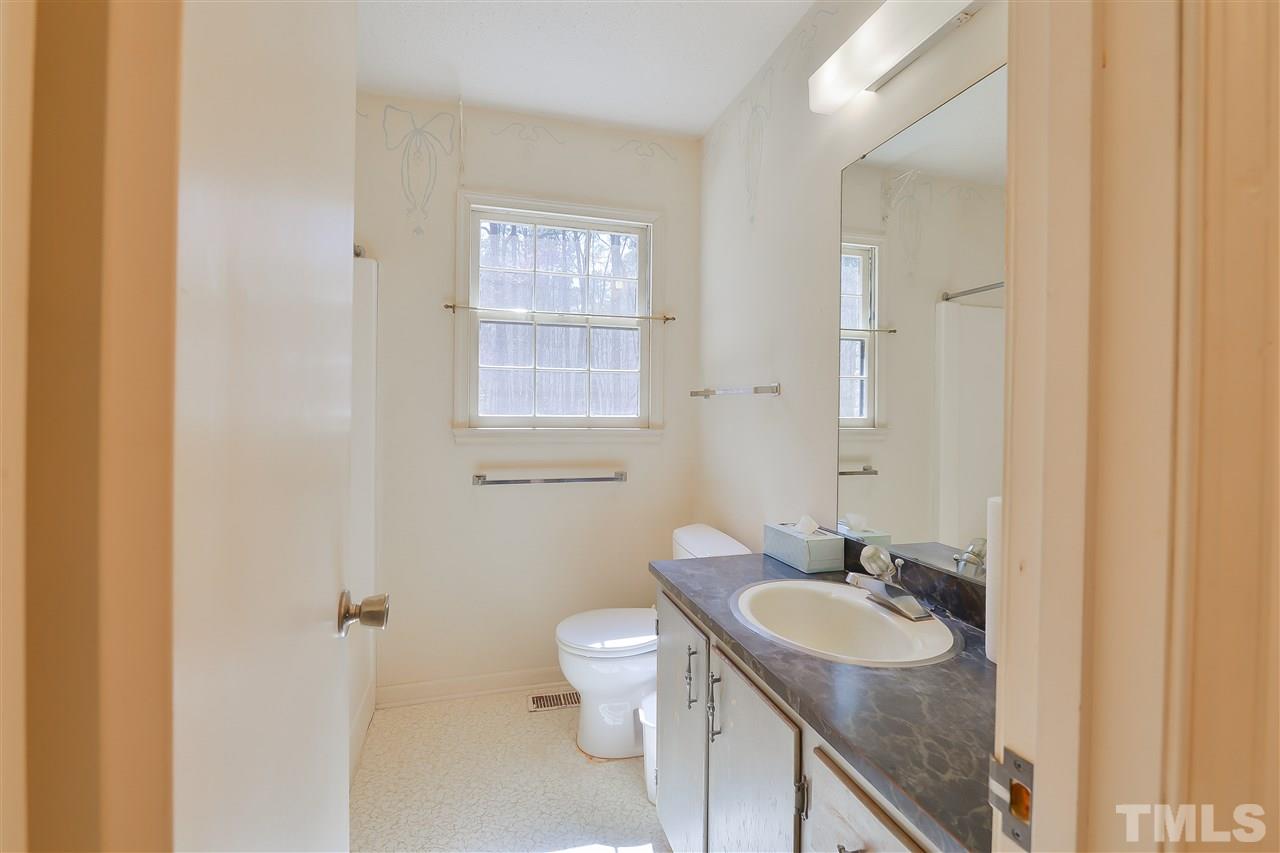 6712 Laurdane Road Raleigh, NC 27613 - Photo 21 of 25 a bathroom with a sink toilet and shower