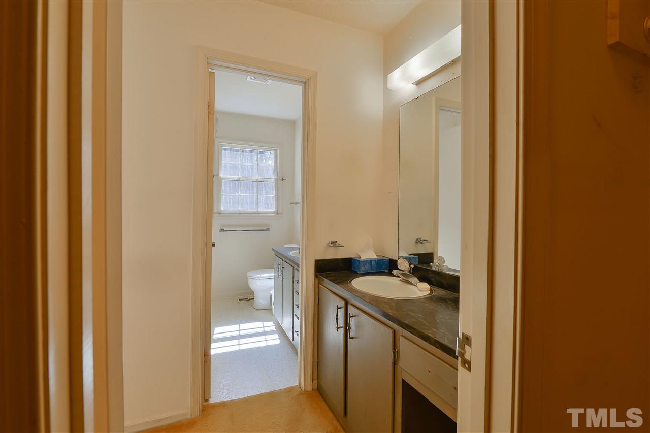 6712 Laurdane Road Raleigh, NC 27613 - Photo 22 of 25 a bathroom with a sink a toilet and a shower
