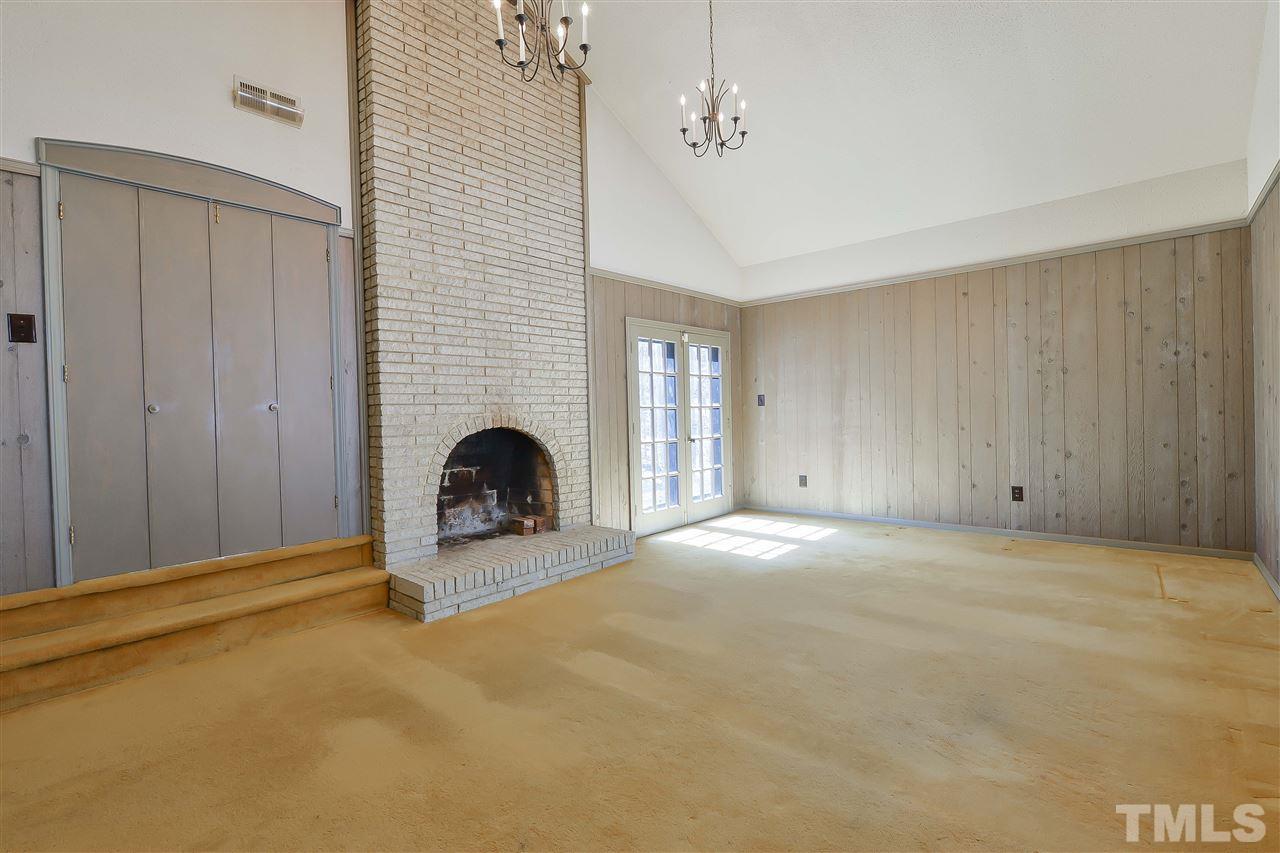 6712 Laurdane Road Raleigh, NC 27613 - Photo 6 of 25 a view of a livingroom with a fireplace and a window
