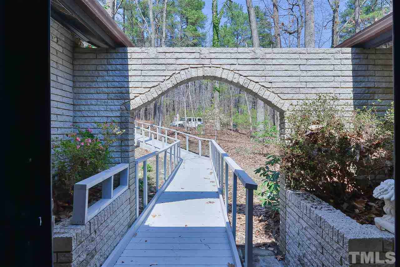6712 Laurdane Road Raleigh, NC 27613 - Photo 10 of 25 a front view of a house with wooden stairs and deck