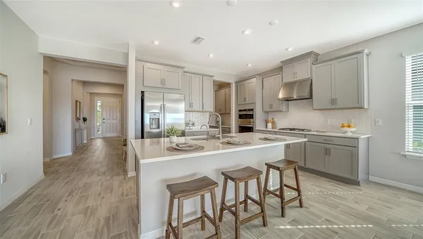 a bathroom with a granite countertop sink a toilet and shower