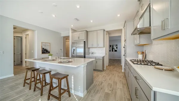 a bathroom with a tub sink shower and mirror