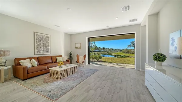 a living room with furniture and a large window