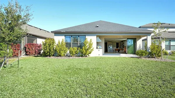 an aerial view of multiple houses with a yard