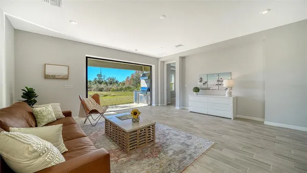 a living room with furniture and a wooden floor