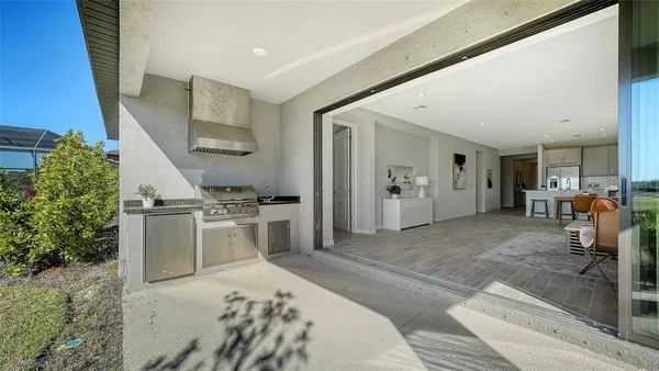 a kitchen with stainless steel appliances a table chairs stove and cabinets