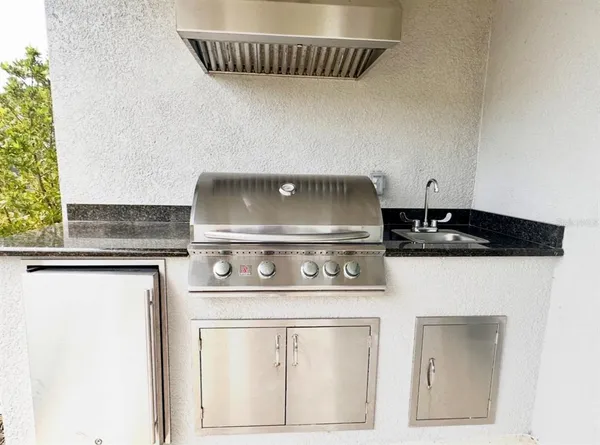 a kitchen with stainless steel appliances a sink stove and refrigerator
